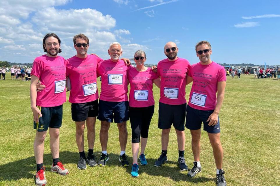 A group of individuals wearing pink shirts.